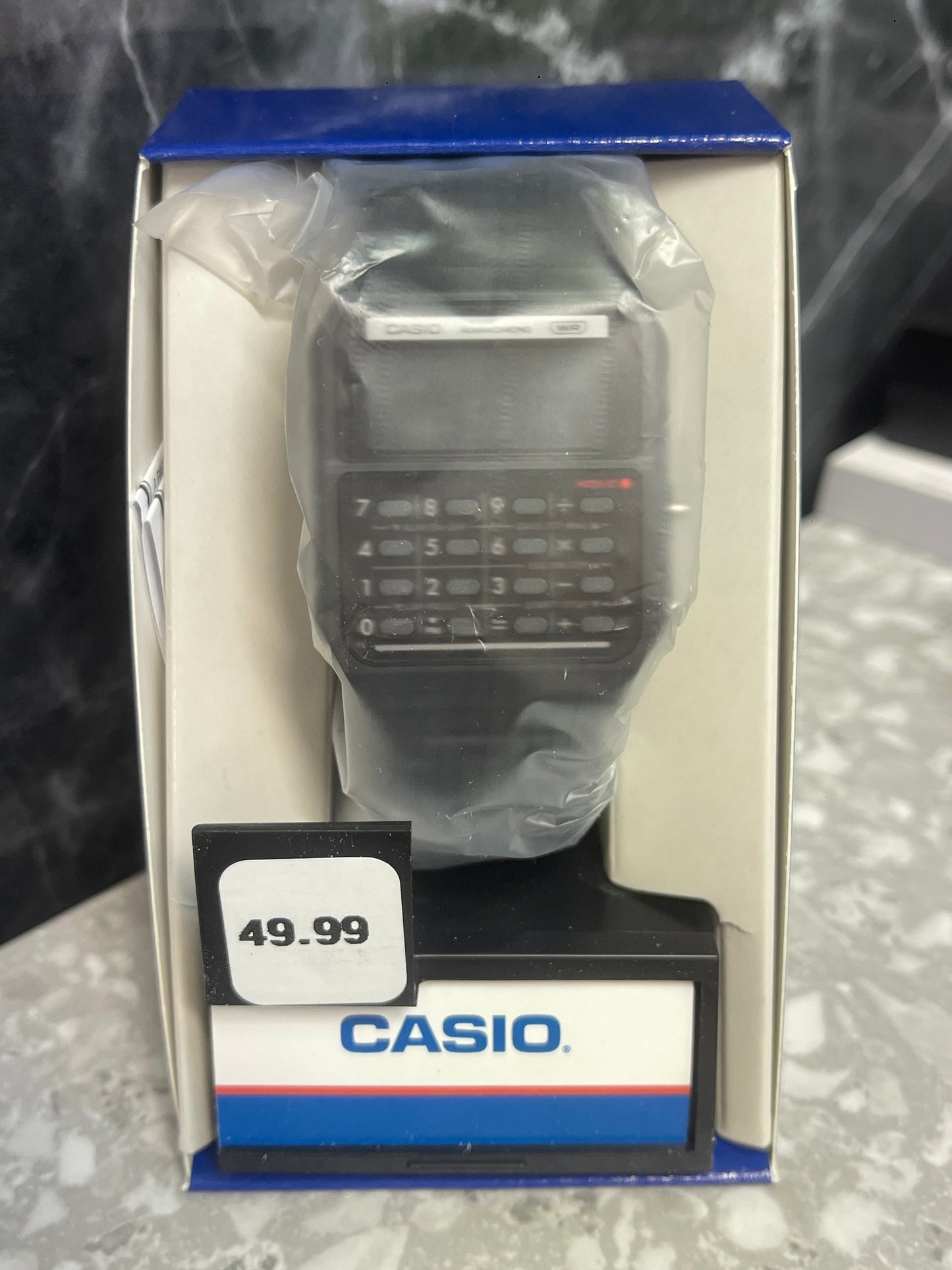 Casio CA-53WB-1BCF calculator watch detail showing digital display and calculator buttons