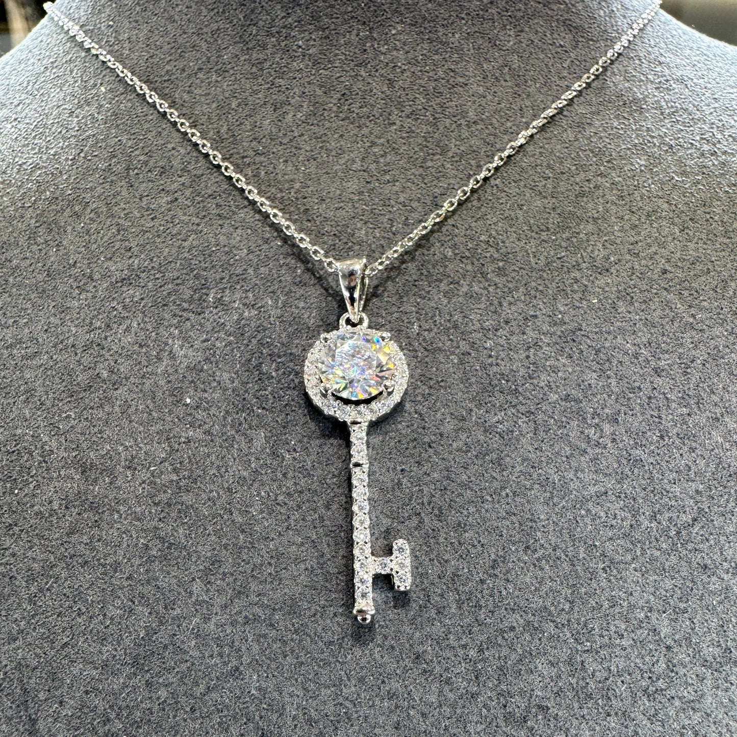 Sterling silver key pendant detail showing 1ct moissanite stone brilliant fire Model MJE1101