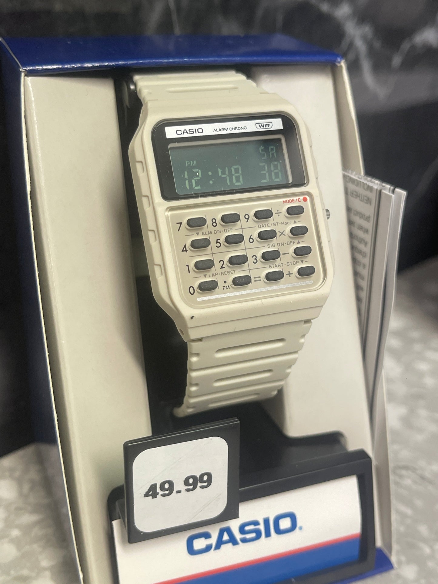 Casio CA-53WB-8BCF calculator watch detail showing digital display and calculator buttons grey
