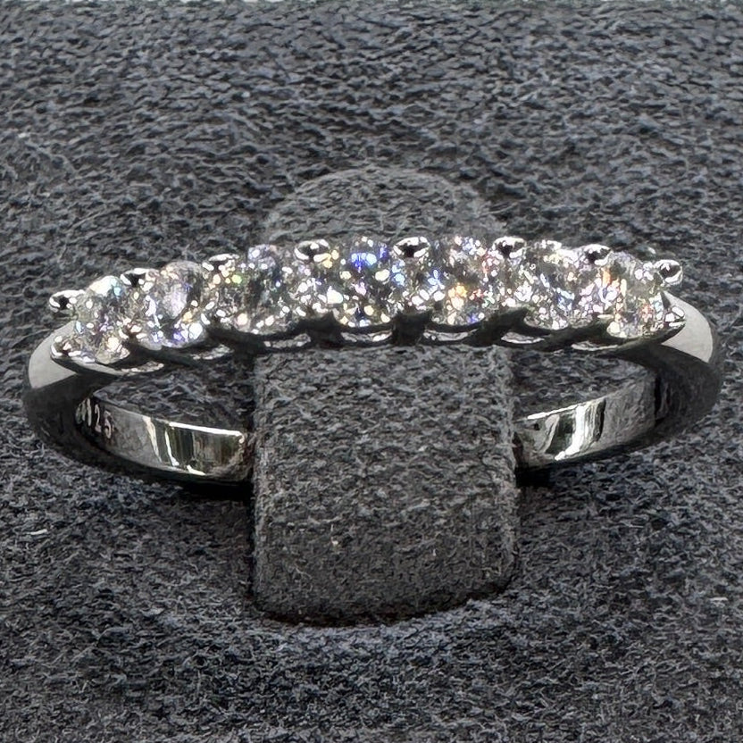 Gray jewelry box with a ring on a light gray background